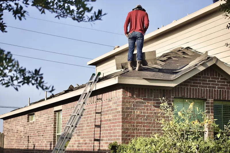 Professional roofer working on a residential roof in Morrow